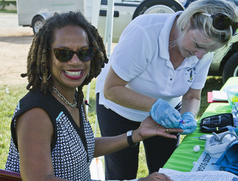 Minister Wilson visits "Taking it to the Streets" health check by Community Nursing
